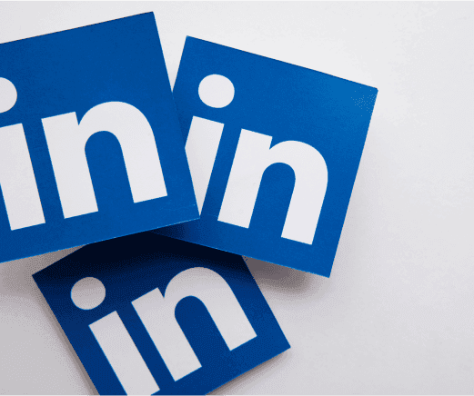 Overlapping LinkedIn logos on a light background